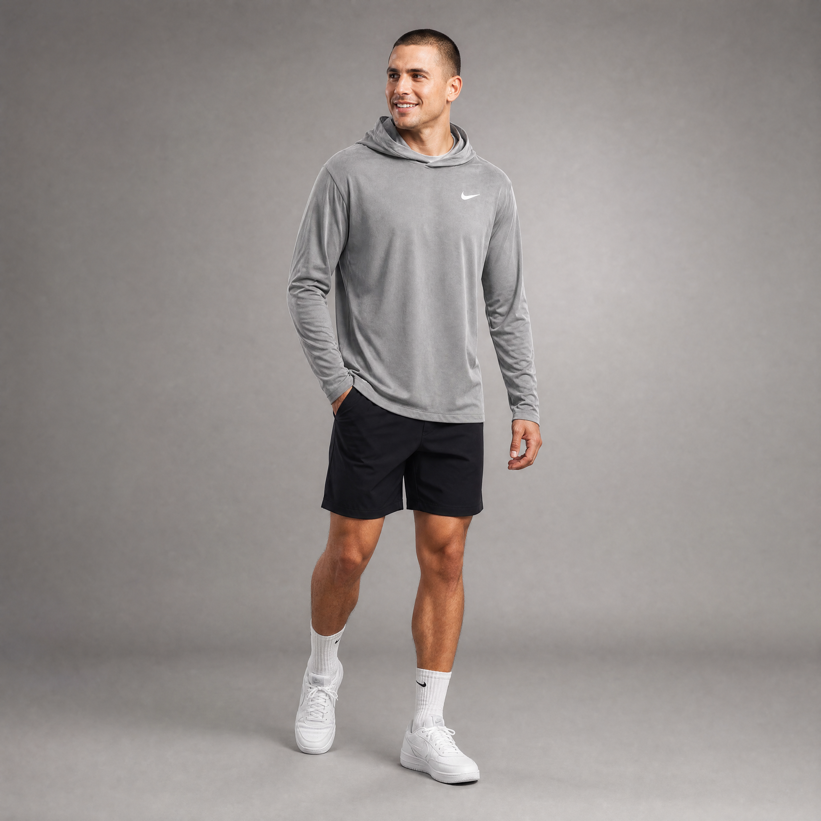 Male athlete modeling the gray Nike Dri-FIT Long Sleeve Hoodie Tee