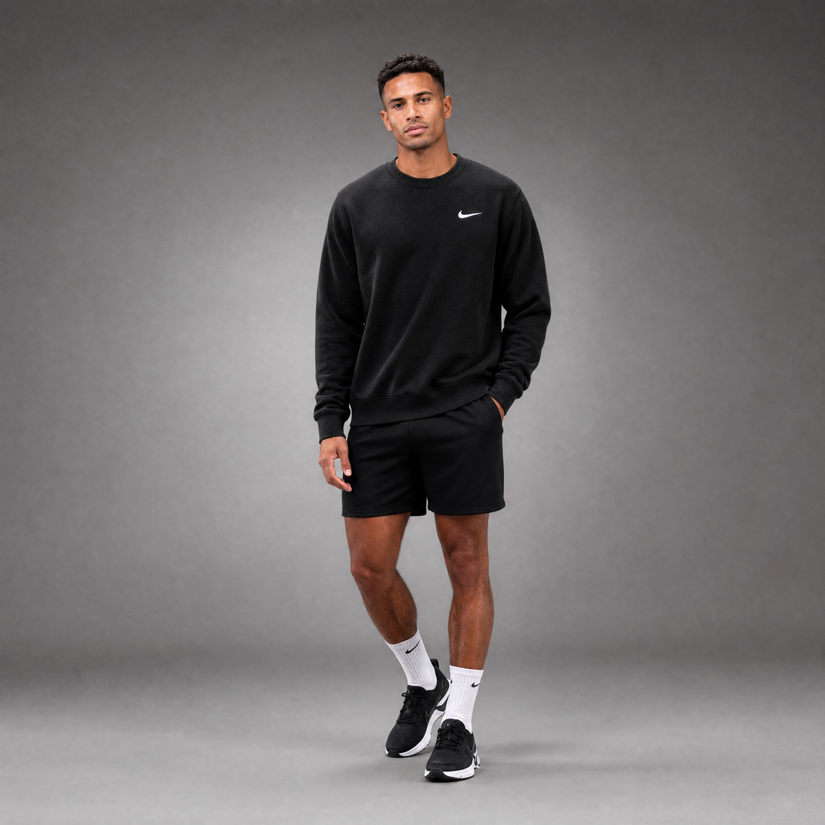 Male athlete modeling the black FCTR Apparel Nike Men's Club Fleece Crew