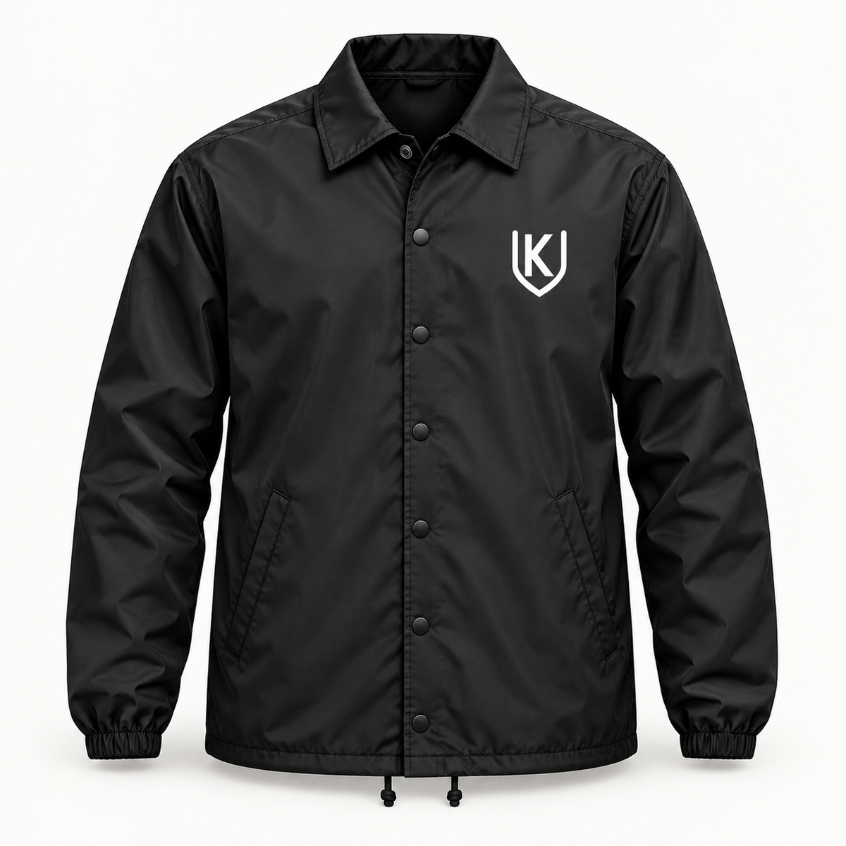 Black Krum County United snap-front coach jacket with a small white shield mark on the left chest.